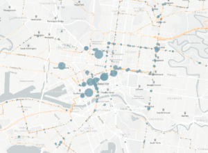Washed out grey close up map of inner Melbourne showing light blue dots of various sizes to indicate bus stop usage and thin orange lines to show where bus routes run