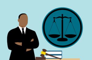 Clip art of a lawyer standing in front of a blue background with legal images and a gavel around them